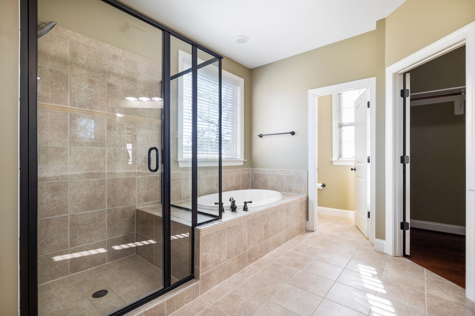 White Ceramic Bathtub Near Glass Door